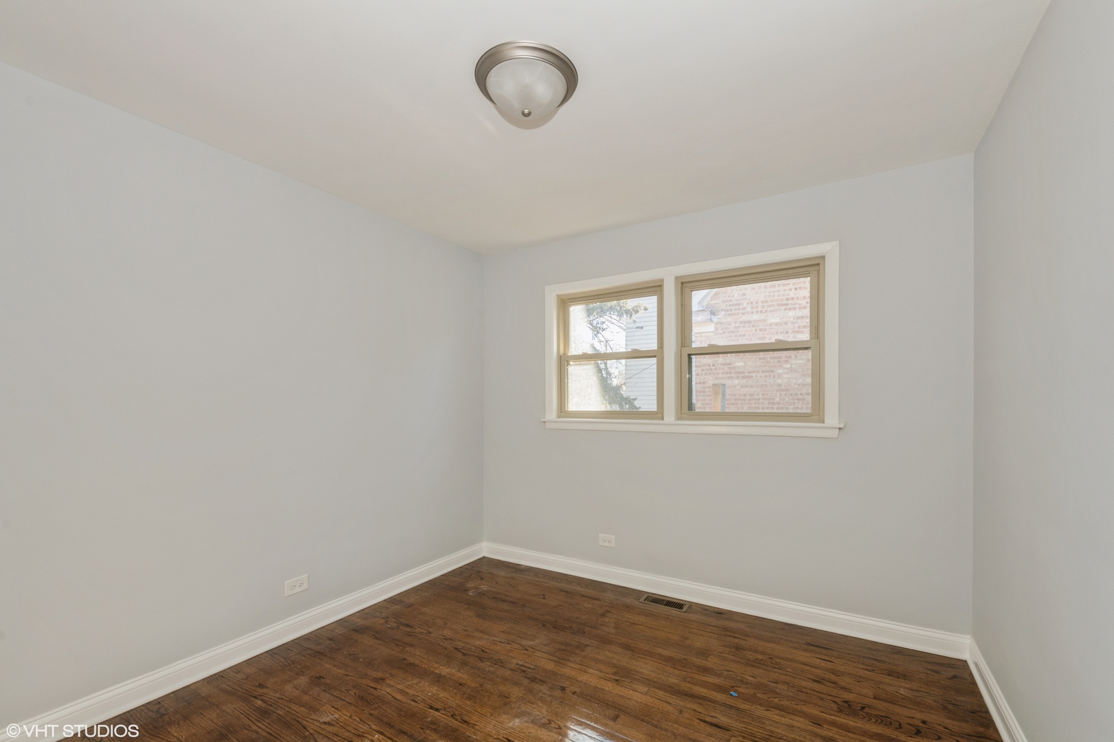 1023 Rice Avenue Bellwood, IL 60104 - Photo 7 of 12 an empty room with wooden floor and windows