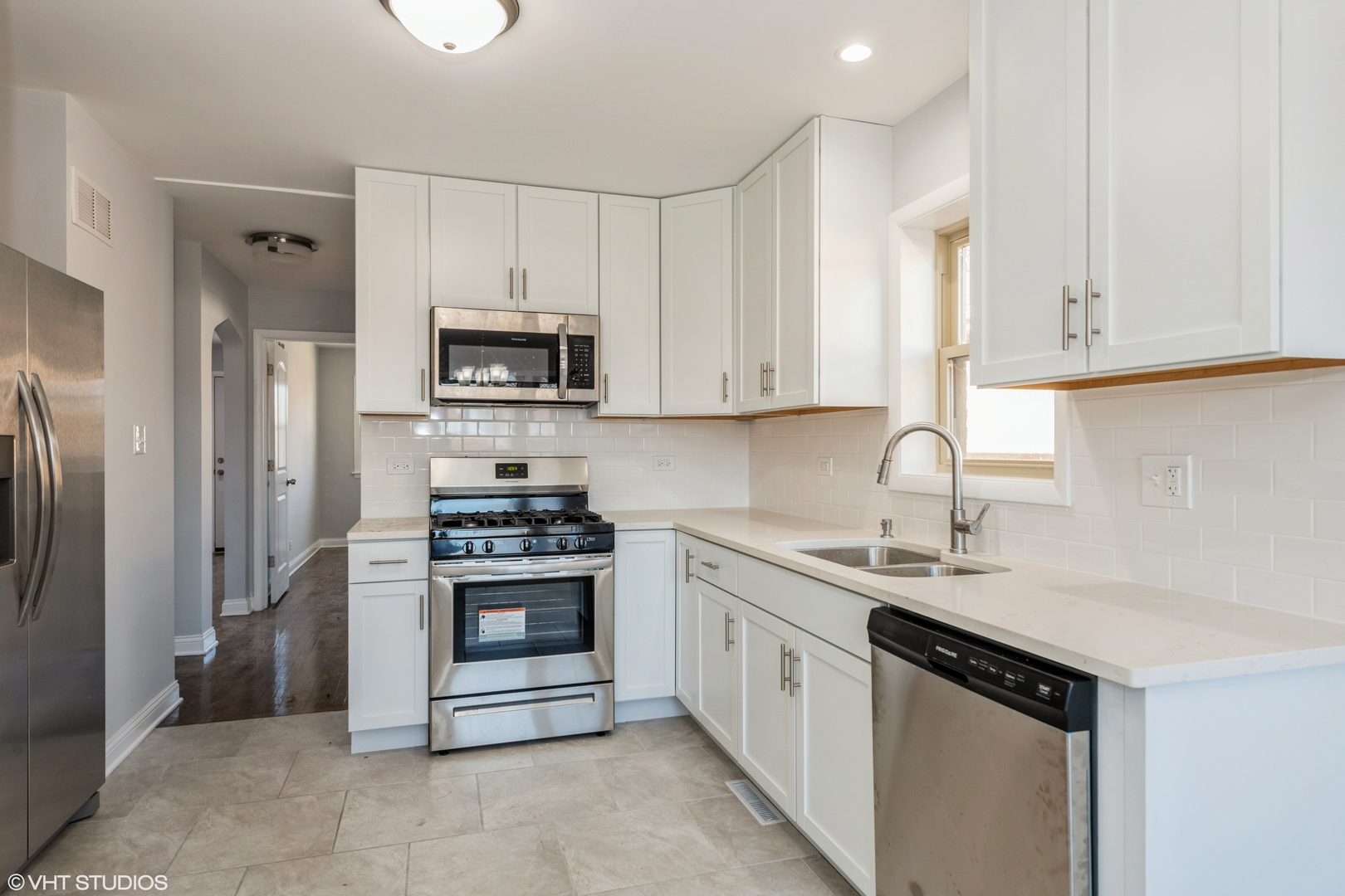 1023 Rice Avenue Bellwood, IL 60104 - Photo 9 of 12 a kitchen with stainless steel appliances granite countertop a stove a sink and a refrigerator