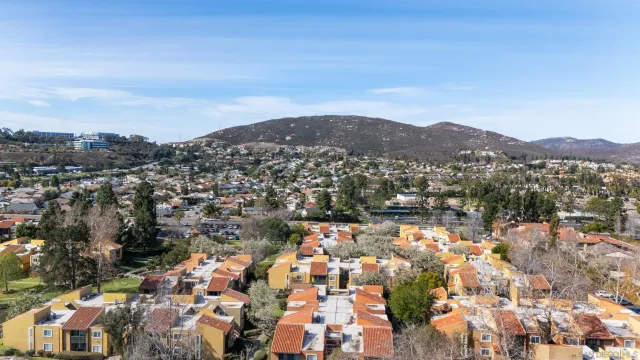 an aerial view of residential houses with city view