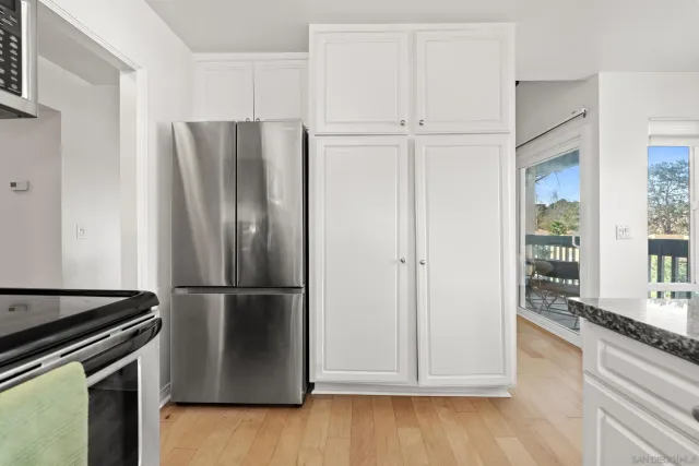 a kitchen with stainless steel appliances a refrigerator and a sink