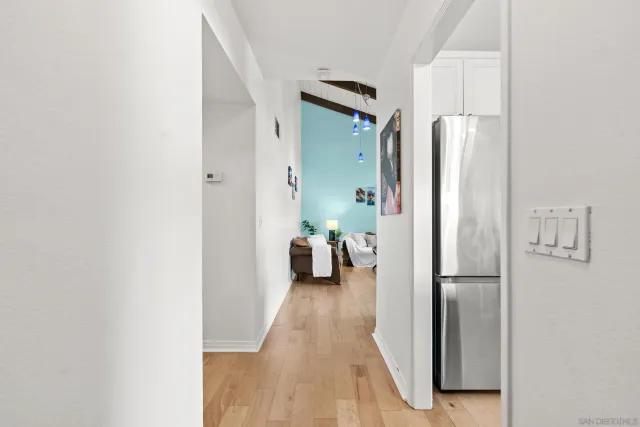 a view of a hallway with a livingroom and a couch