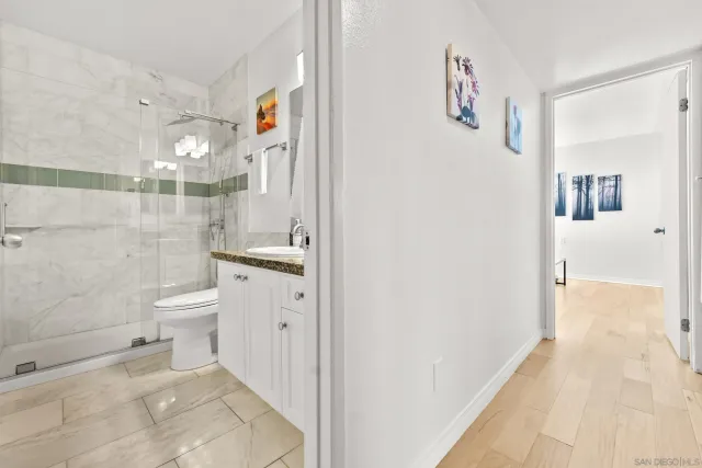 a bathroom with a toilet sink and shower