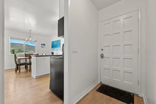 a kitchen with white cabinets and refrigerator
