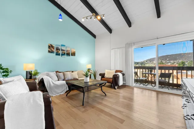 a living room with furniture and a floor to ceiling window