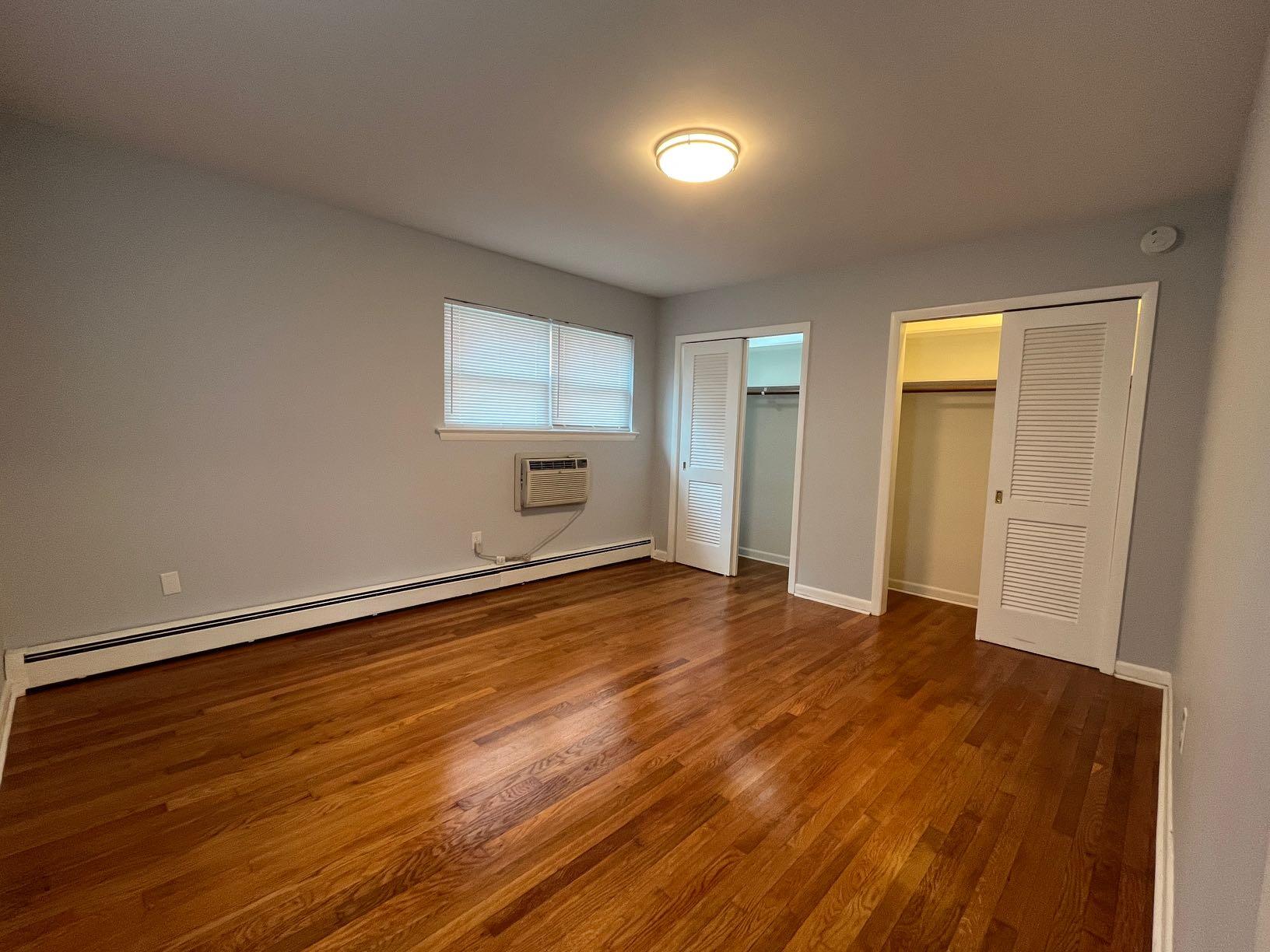 2209 Jefferson Street Southwest, Unit B Roanoke, VA 24014 - Photo 11 of 12 an empty room with wooden floor and windows