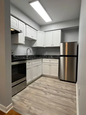 a kitchen with a sink stove and refrigerator
