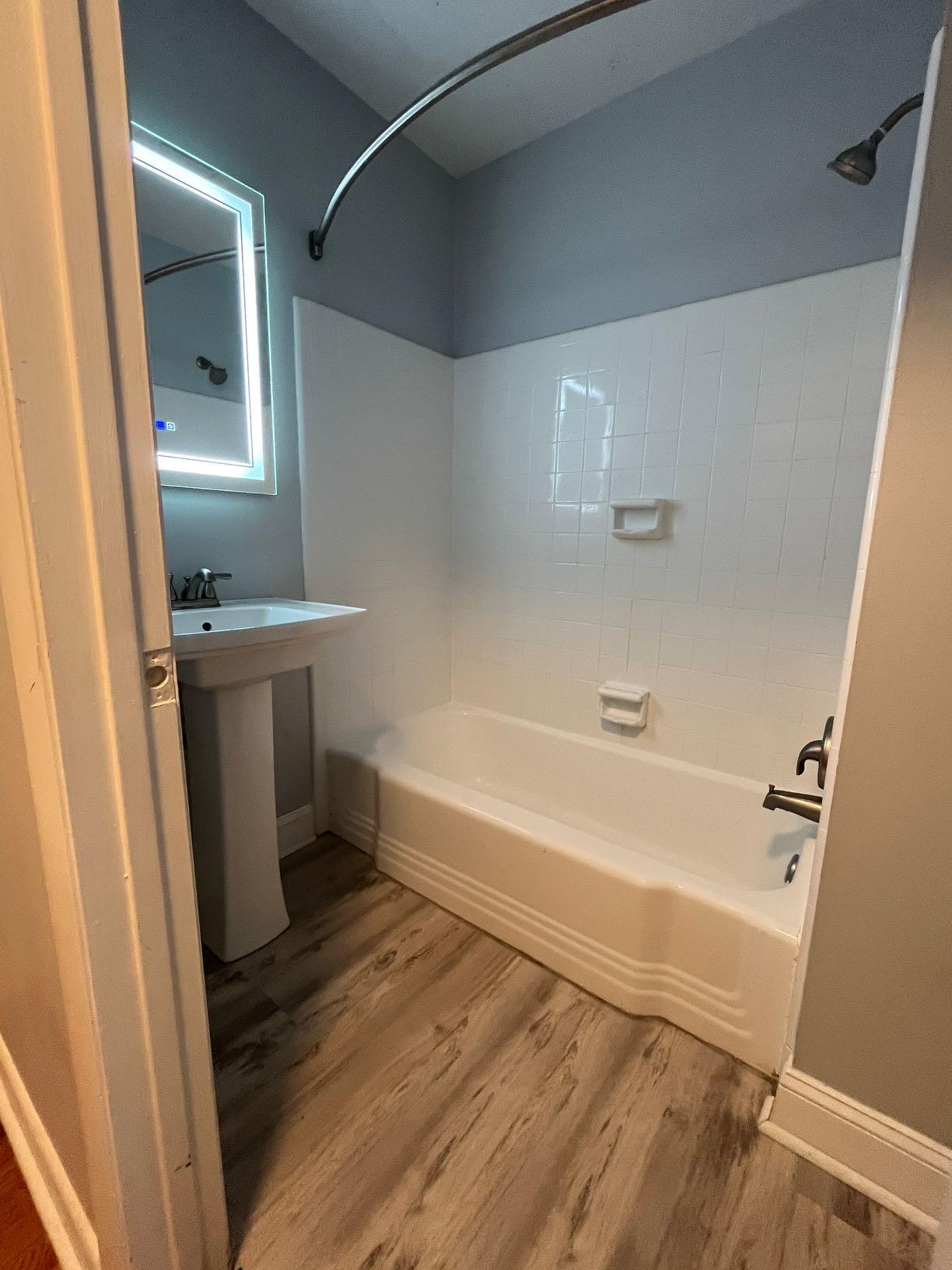 2209 Jefferson Street Southwest, Unit B Roanoke, VA 24014 - Photo 9 of 12 a bathroom with a tub a sink and a mirror