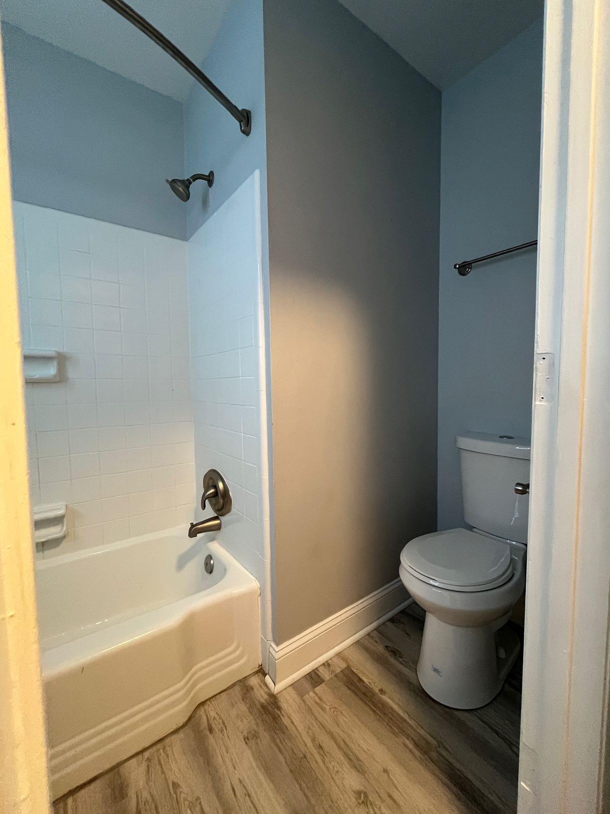 2209 Jefferson Street Southwest, Unit B Roanoke, VA 24014 - Photo 10 of 12 a white toilet sitting next to a bath tub