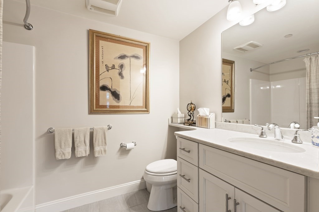 2 Manor Terrace, Unit 209 Lexington, MA 02420 - Photo 21 of 26 a bathroom with a sink vanity mirror and toilet