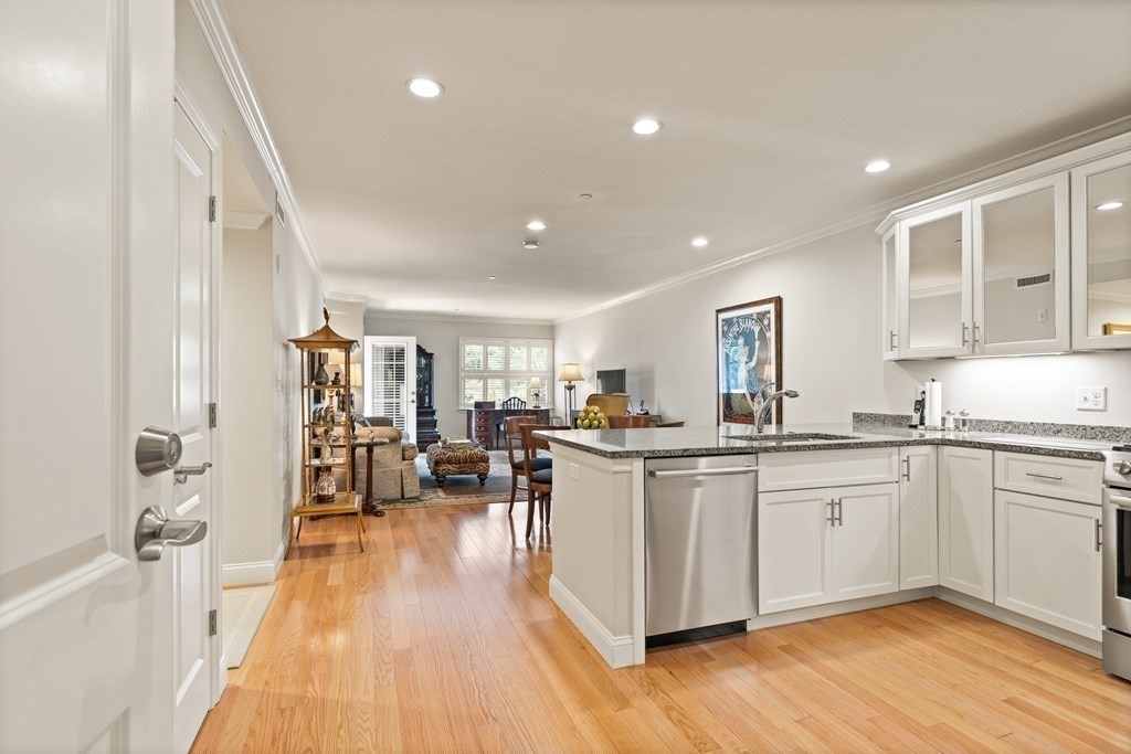 2 Manor Terrace, Unit 209 Lexington, MA 02420 - Photo 4 of 26 a kitchen with sink cabinets and wooden floor