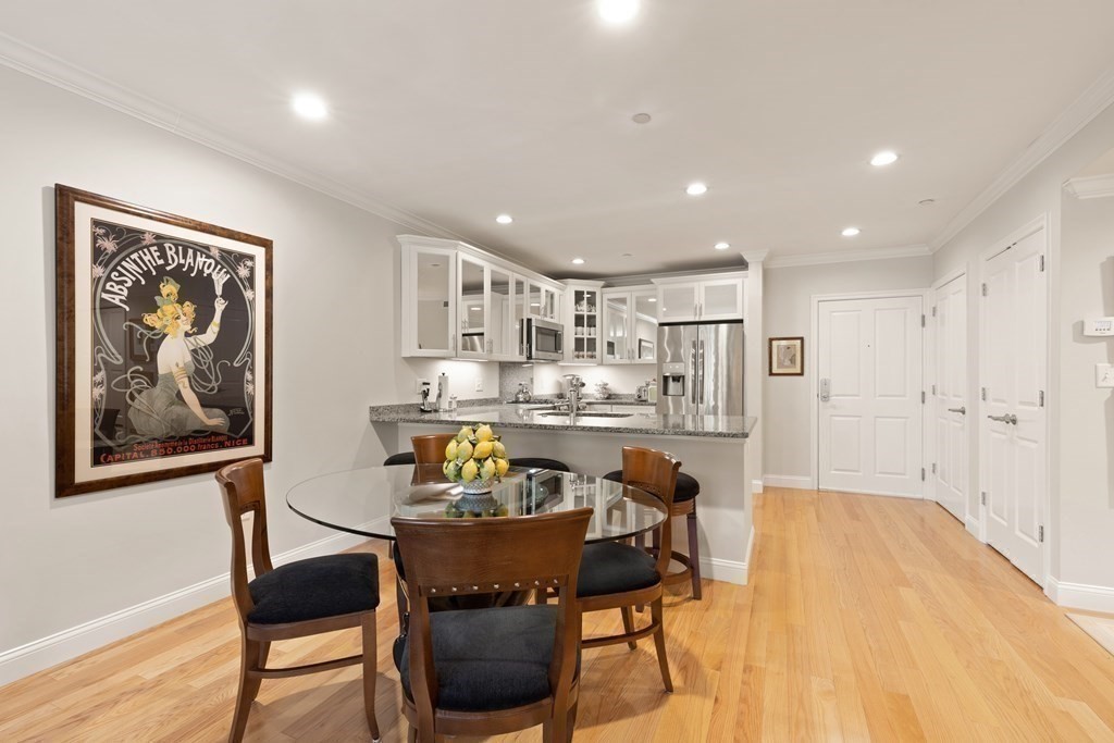 2 Manor Terrace, Unit 209 Lexington, MA 02420 - Photo 9 of 26 a view of a dining room with furniture and wooden floor