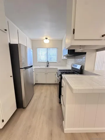 a kitchen with a refrigerator a sink and dishwasher