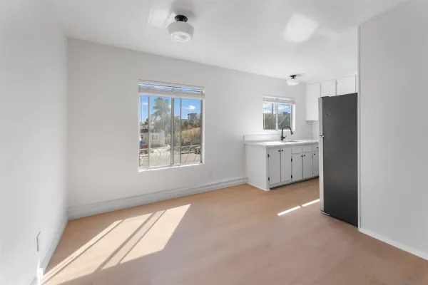 a view of a kitchen with a sink dishwasher and a refrigerator