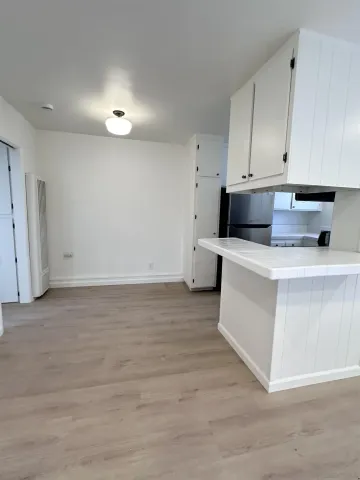 a kitchen with stainless steel appliances white cabinets and a sink