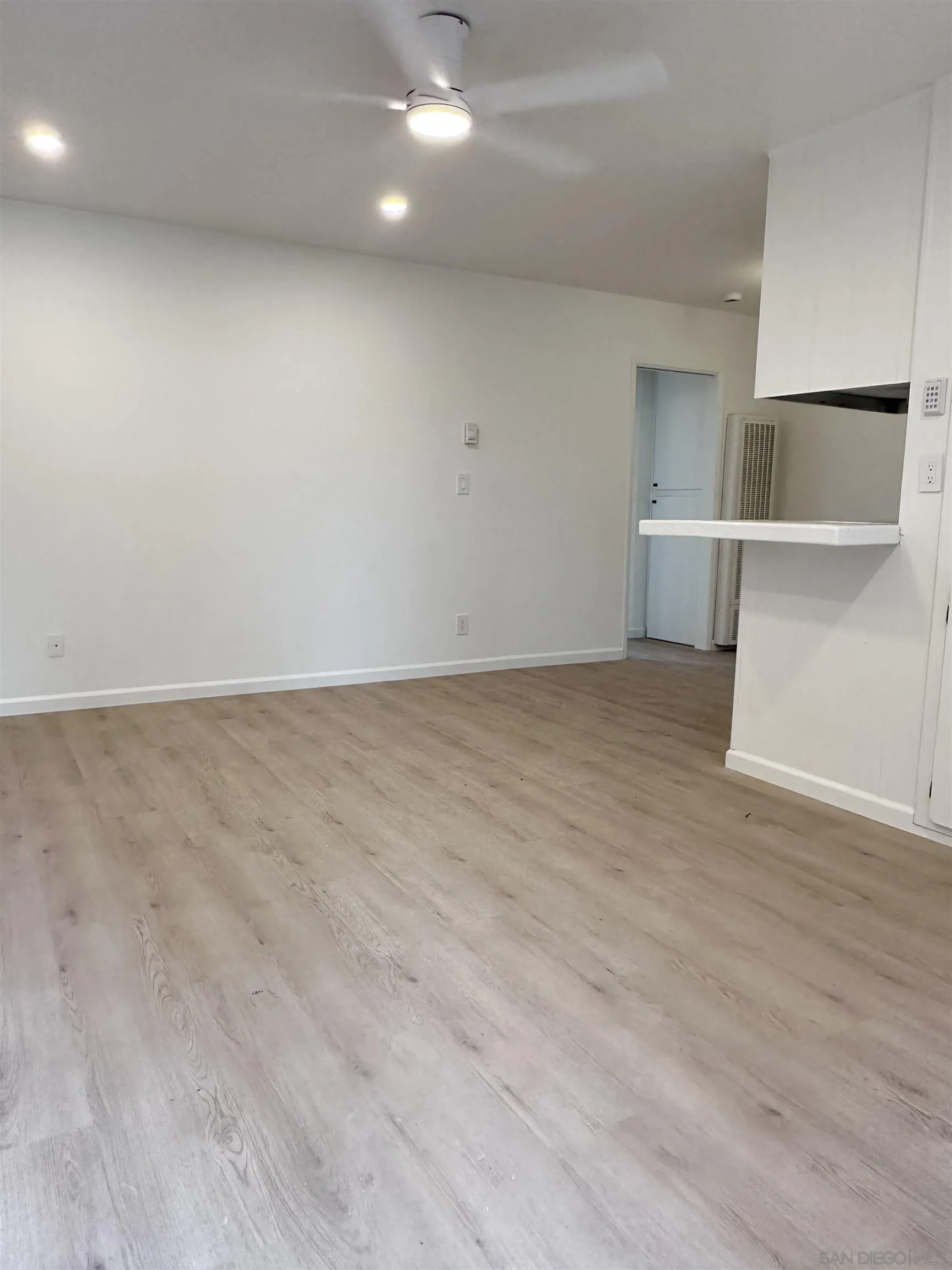 930 B B Avenue, Unit 22 National City, CA 91950 - Photo 7 of 14 an empty room with wooden floor and windows