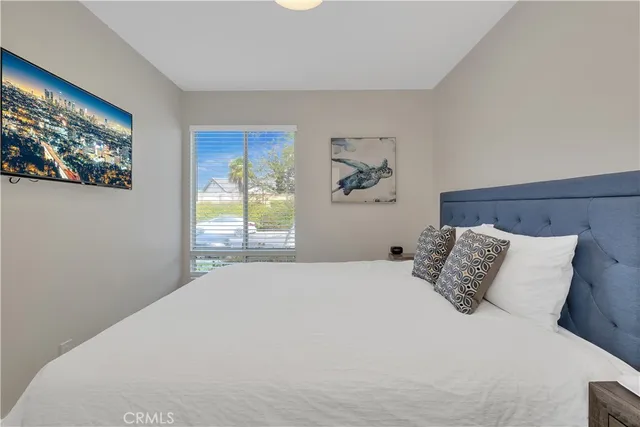 a bedroom with a large bed and a window