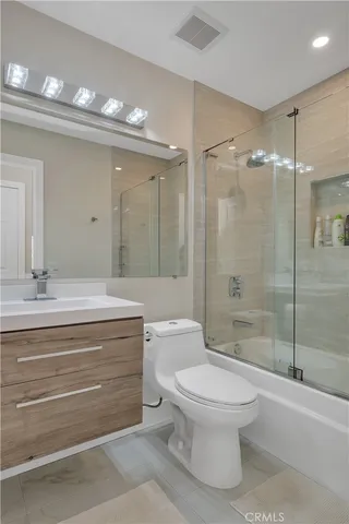 a bathroom with a toilet a sink and shower