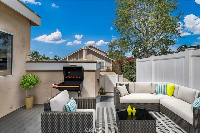 a view of a patio with couches chairs and a potted plant
