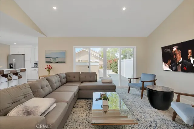 a living room with furniture a rug and a large window