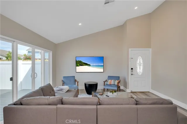 a living room with furniture a fireplace and a large window