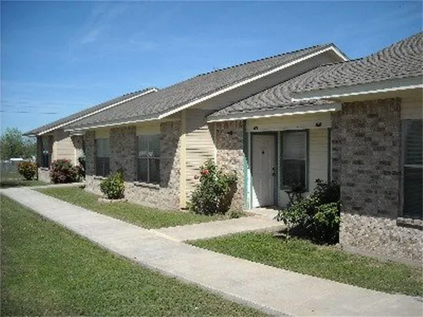 a view of a house with backyard and porch