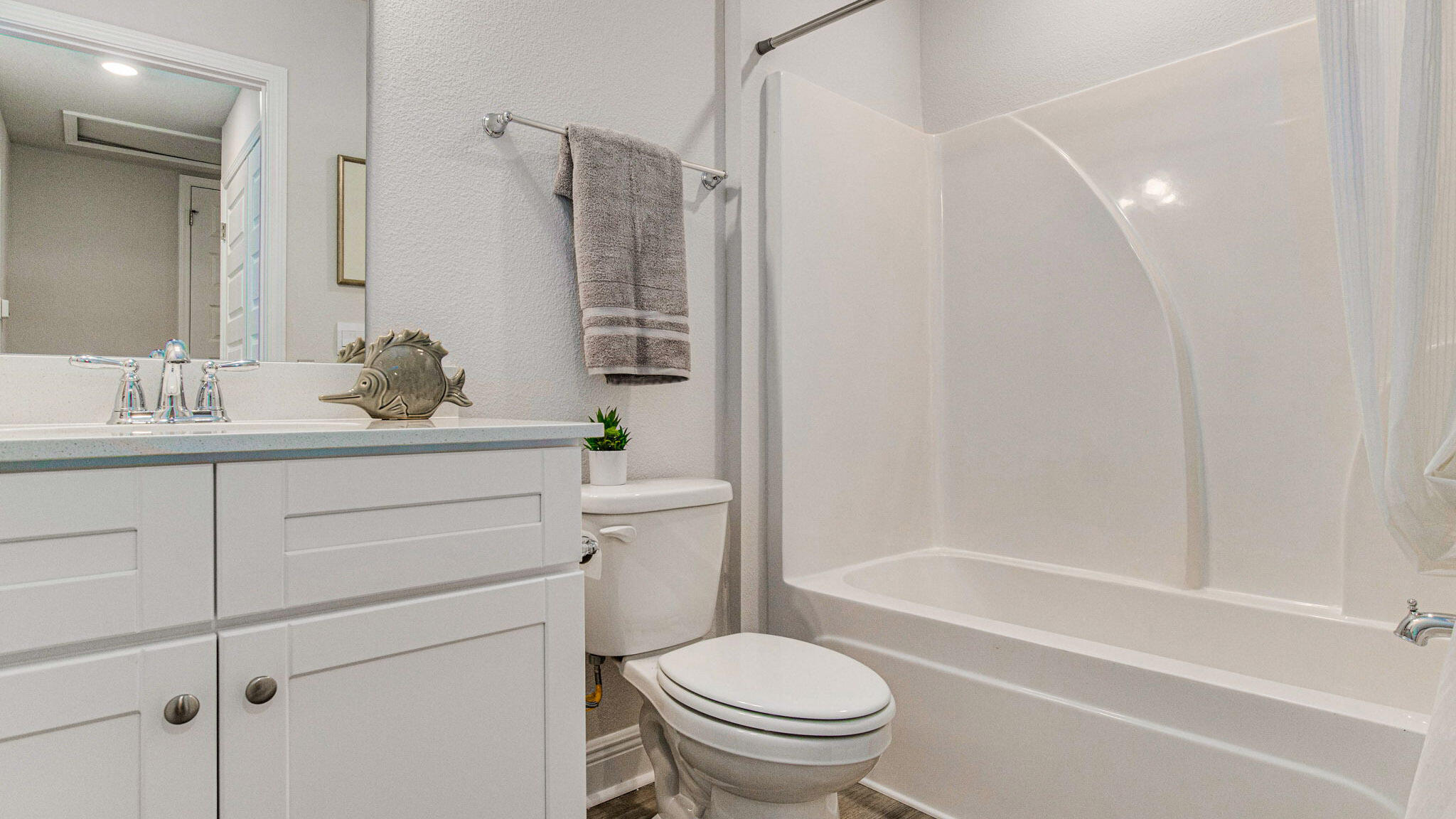 8553 Midtown Court Navarre, FL 32566 - Photo 26 of 27 a bathroom with a sink toilet vanity and shower