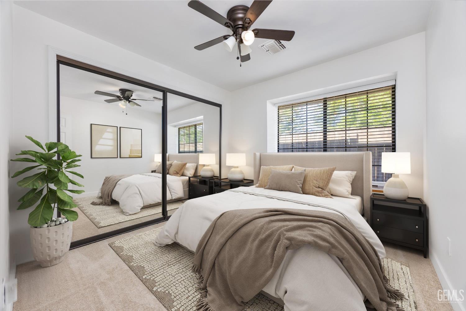 Undisclosed Address Bakersfield, CA 93314 - Photo 18 of 69 a bedroom with a large bed and a chandelier