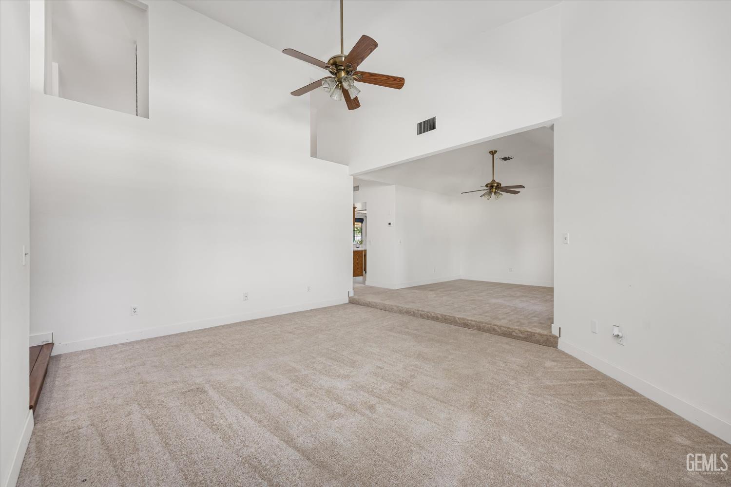 Undisclosed Address Bakersfield, CA 93314 - Photo 24 of 69 an empty room with a ceiling fan and carpet