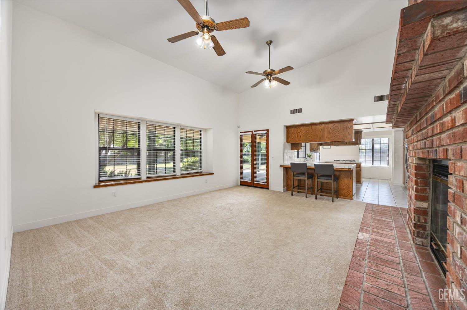 Undisclosed Address Bakersfield, CA 93314 - Photo 27 of 69 a view of a livingroom with a flat screen tv a ceiling fan and a fireplace