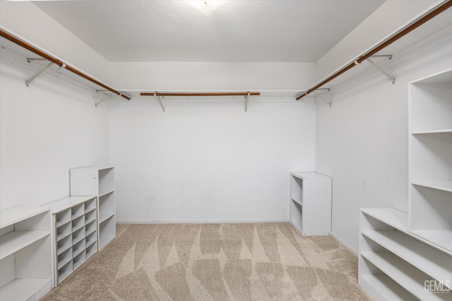 Undisclosed Address Bakersfield, CA 93314 - Photo 42 of 69 a view of walk in closet with empty racks