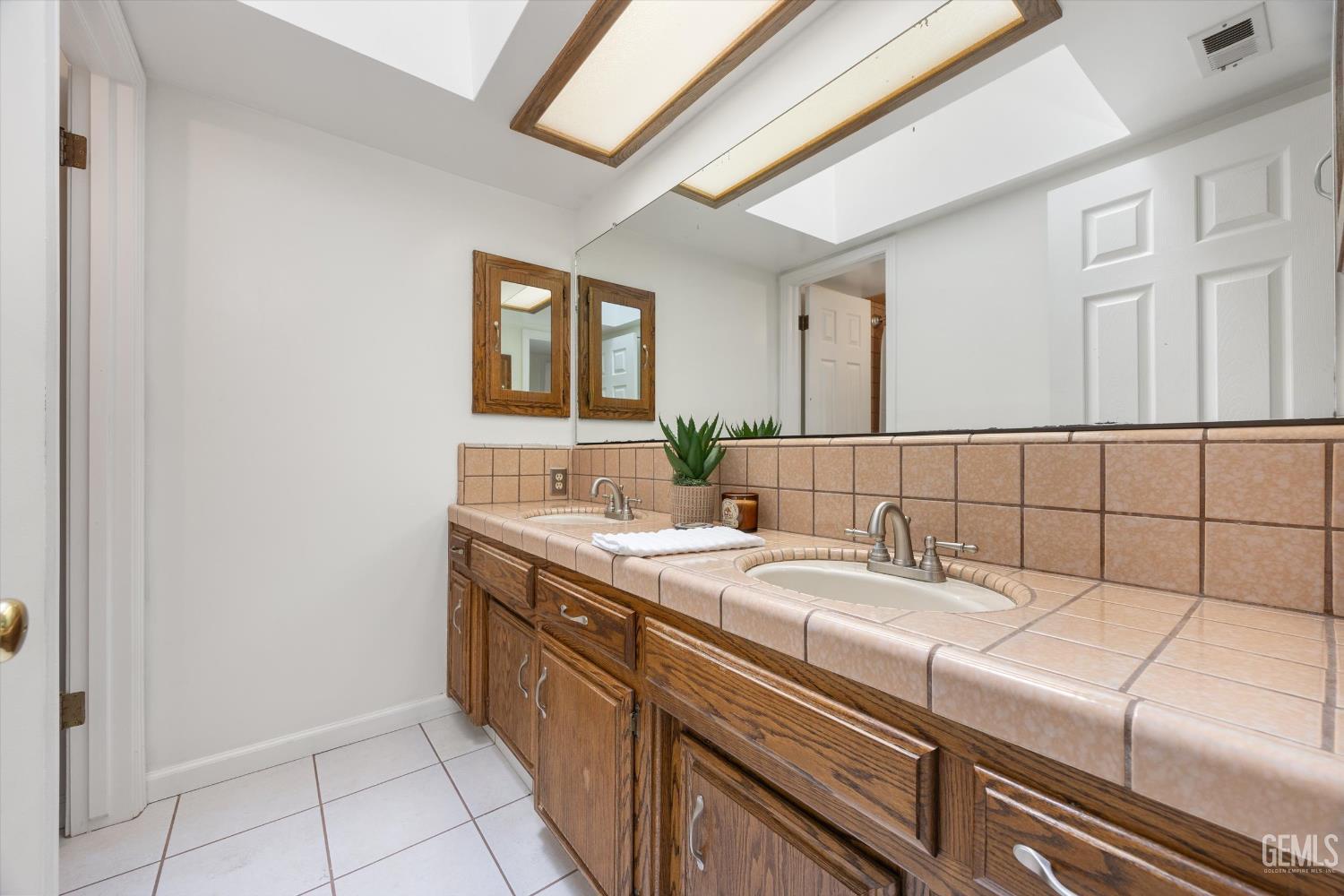 Undisclosed Address Bakersfield, CA 93314 - Photo 45 of 69 a bathroom with a sink and a mirror