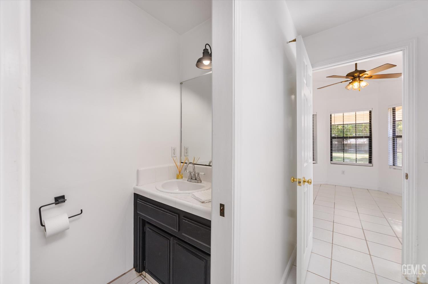 Undisclosed Address Bakersfield, CA 93314 - Photo 49 of 69 a bathroom with a sink vanity and a mirror