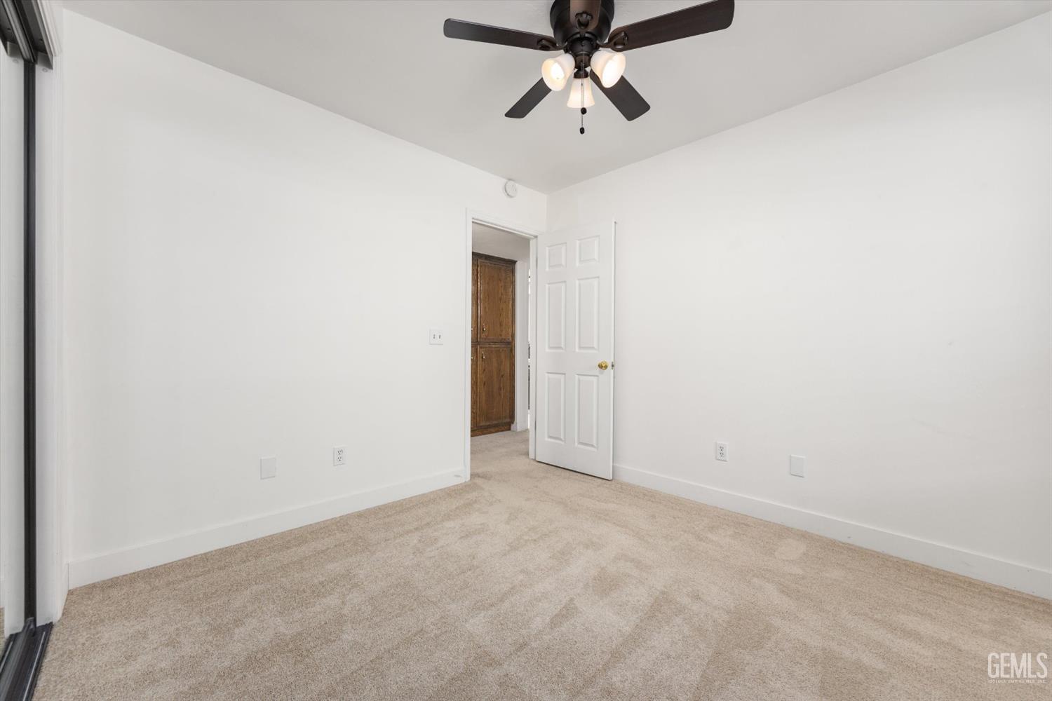 Undisclosed Address Bakersfield, CA 93314 - Photo 53 of 69 an empty room with a ceiling fan and carpet