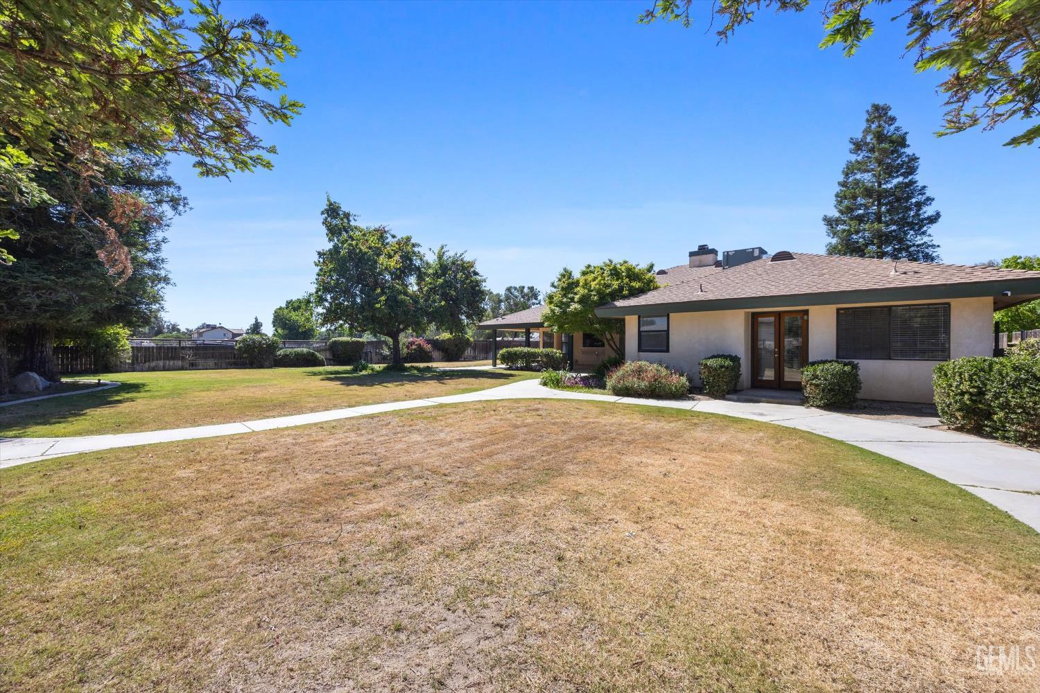 Undisclosed Address Bakersfield, CA 93314 - Photo 61 of 69 a view of a house with swimming pool and a yard