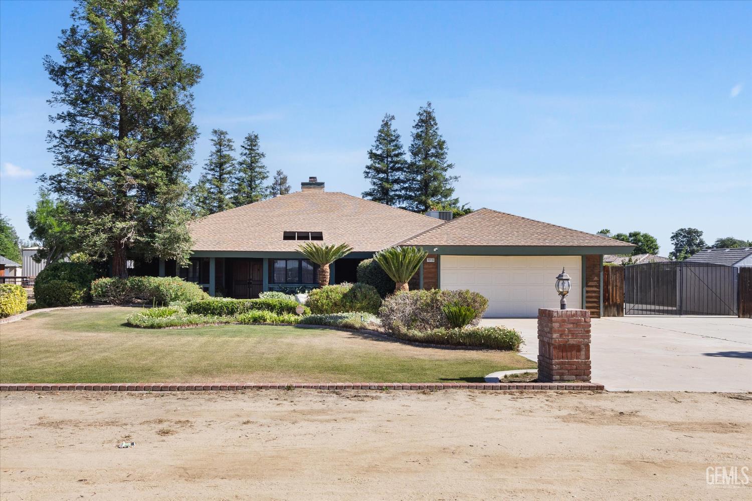 Undisclosed Address Bakersfield, CA 93314 - Photo 9 of 69 a front view of a house with a yard and garage