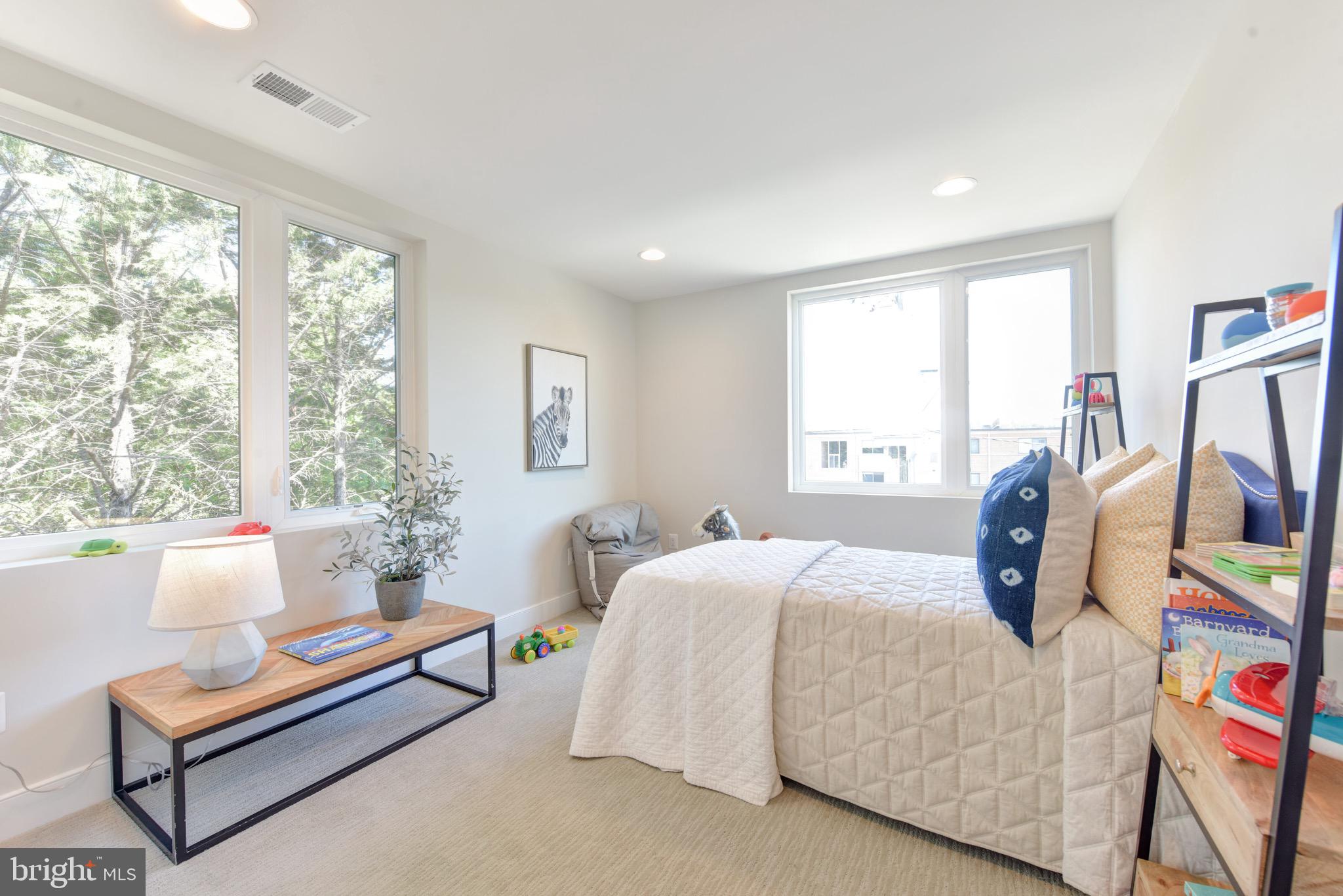 2823 24th Road South Arlington, VA 22206 - Photo 14 of 97 a bedroom with a bed a couch and large window