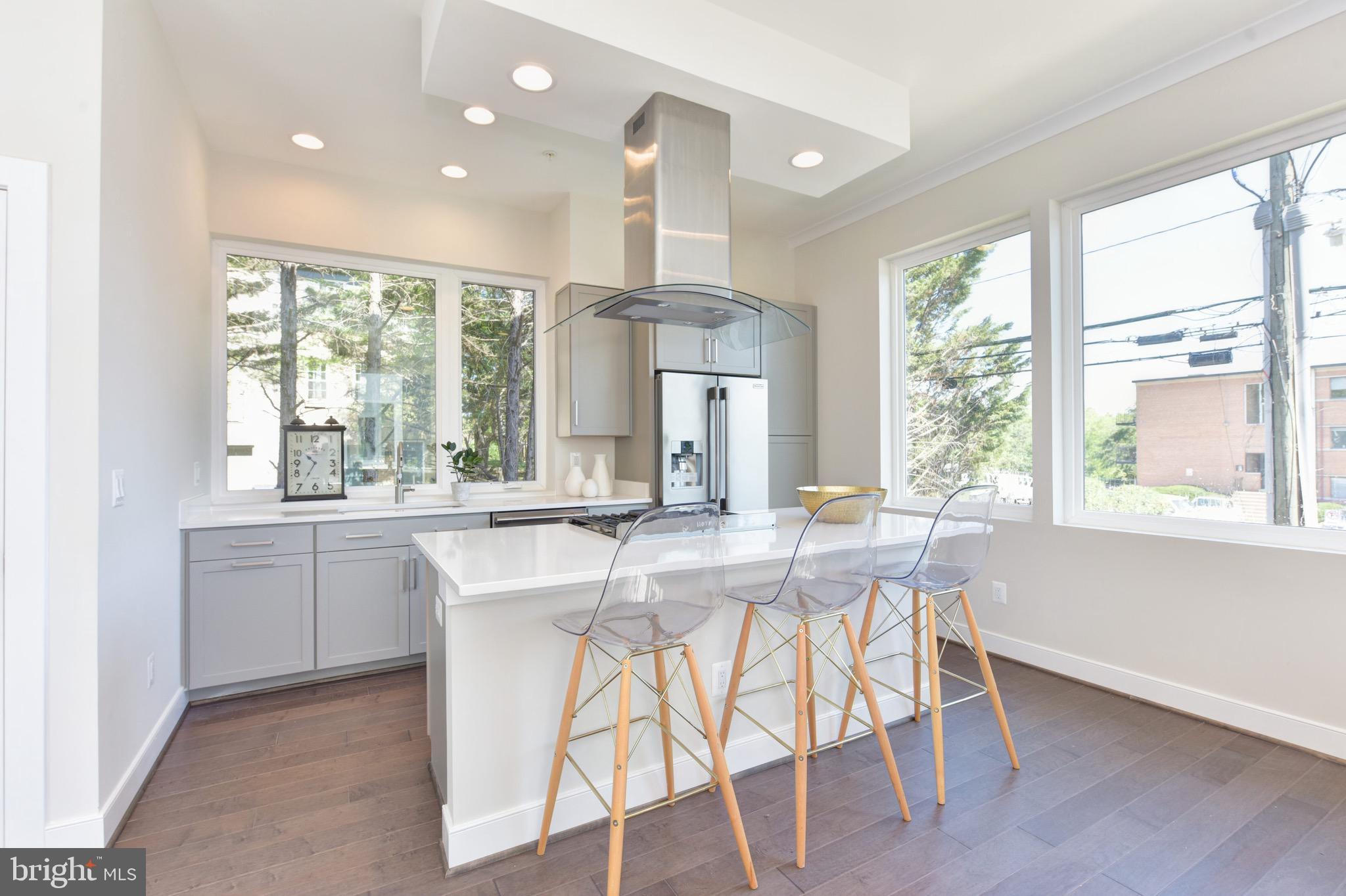 2823 24th Road South Arlington, VA 22206 - Photo 5 of 97 a kitchen with stainless steel appliances a dining table chairs and wooden floor