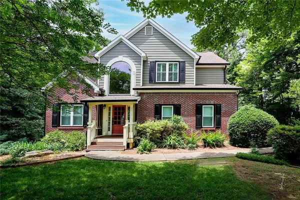 a front view of a house with a yard and porch