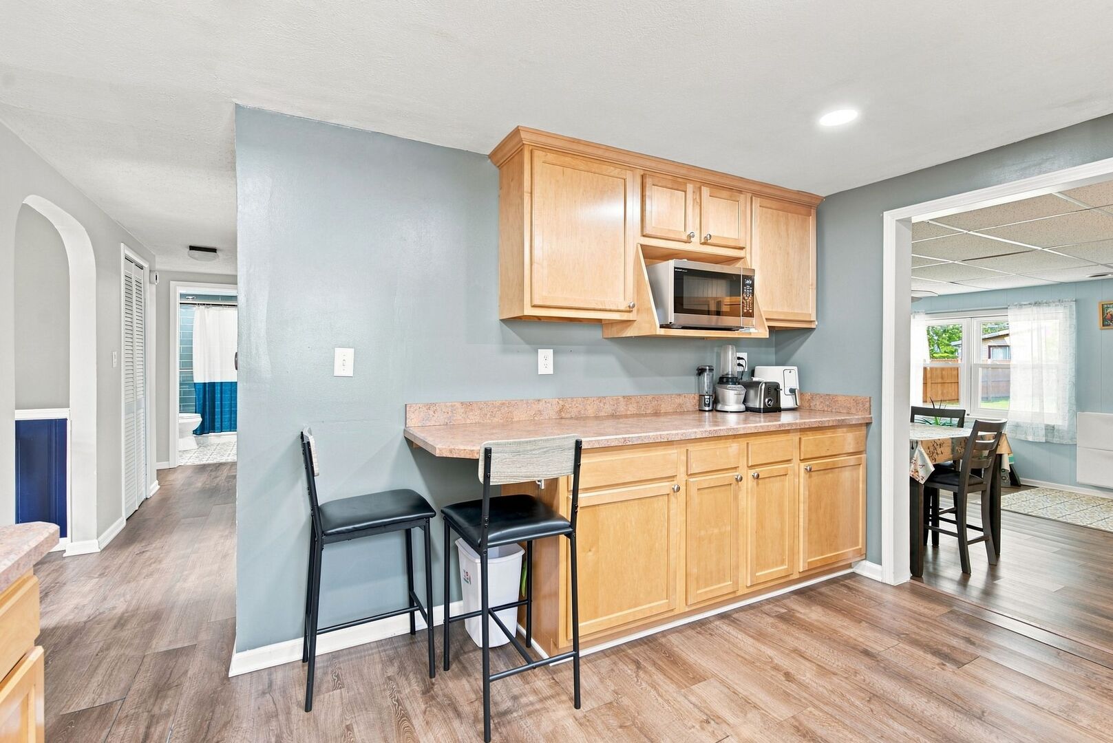 913 Church Road Aurora, IL 60505 - Photo 6 of 31 a kitchen with granite countertop a stove a sink a dining table and chairs