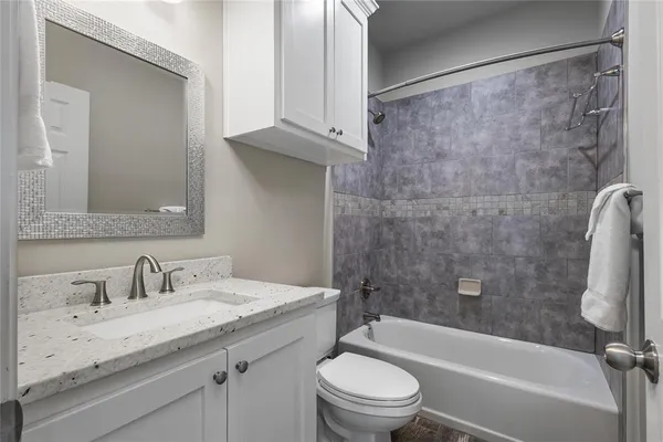 a bedroom with a bed and a couch