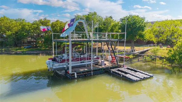 a view of a balcony with chairs and wooden floor