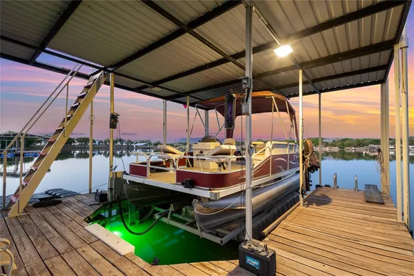 a view of a balcony with floor to ceiling windows and wooden floor