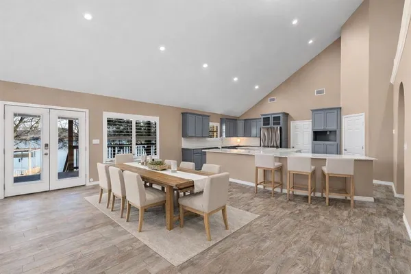 a kitchen with a wooden floor and chairs