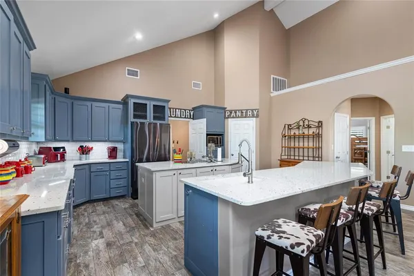 a kitchen with stainless steel appliances granite countertop a sink stove and refrigerator