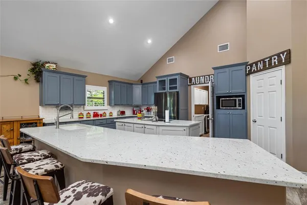 a kitchen with granite countertop a sink and cabinets