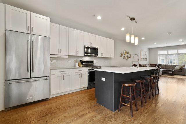 1027 Walnut Way Oak Park, IL 60302 - Photo 15 of 35 a kitchen with stainless steel appliances granite countertop a refrigerator a sink a stove a microwave and a refrigerator