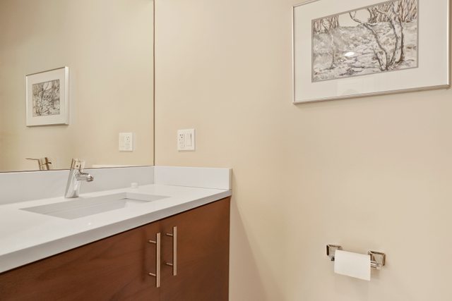 1027 Walnut Way Oak Park, IL 60302 - Photo 18 of 35 a bathroom with a sink and a mirror
