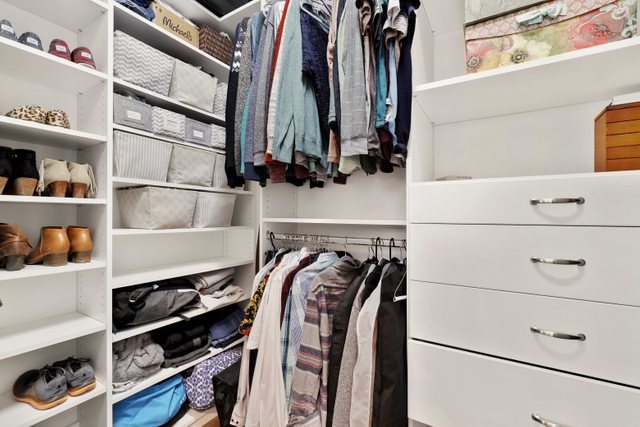 1027 Walnut Way Oak Park, IL 60302 - Photo 24 of 35 a view of walk in closet with clothes and shoes