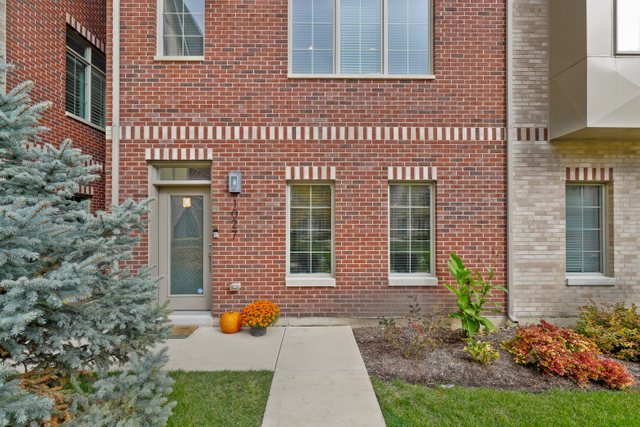 1027 Walnut Way Oak Park, IL 60302 - Photo 3 of 35 a view of a brick house with many windows and plants