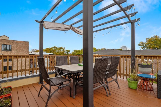 1027 Walnut Way Oak Park, IL 60302 - Photo 32 of 35 a view of a balcony with chairs and wooden floor
